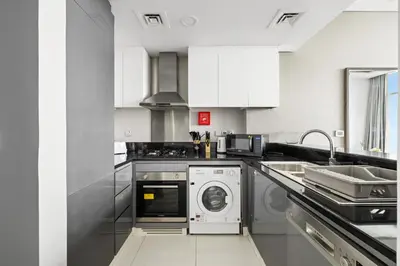 a kitchen with a washing machine and a sink at Beautiful unit with canal view ! DAMAC PRIVE in Dubai