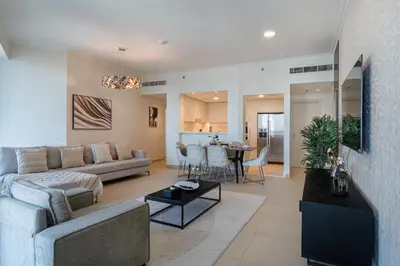 a living room with a couch and a table at Connection to Dubai Mall, 2 King Beds, with Pool, Gym, Tennis Court in Dubai
