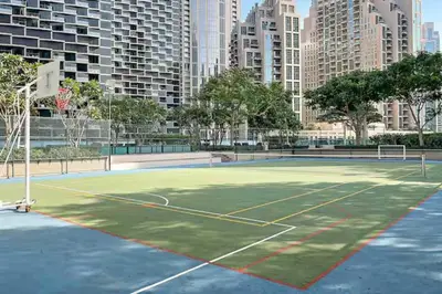 a tennis court in the middle of a city at Connection to Dubai Mall, 2 King Beds, with Pool, Gym, Tennis Court in Dubai