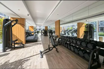 a gym with a row of treadmills and machines at Vogue JVC Luma22 near Circle Mall, Studio Apartment with Balcony and Vibrant Community View, Access to all amenities in Dubai