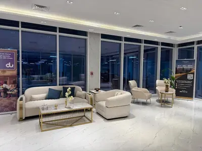 a lobby with couches and chairs in a building at Smart Studio in Gemz in Dubai
