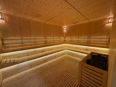 a large empty sauna with wooden floors and ceilings at Smart Studio in Gemz in Dubai
