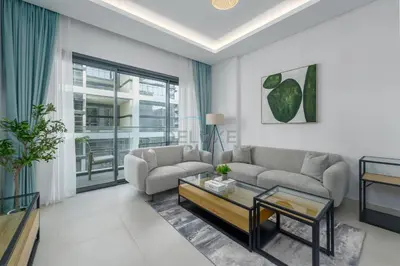 a living room with a couch and a table at Prime location near the park, just minutes from the metro, with easy access to all of Downtown Dubai attractions, Viridian, Al Wasl by Deluxe Holiday Homes in Dubai