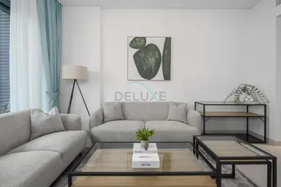 a living room with a couch and a coffee table at Prime location near the park, just minutes from the metro, with easy access to all of Downtown Dubai attractions, Viridian, Al Wasl by Deluxe Holiday Homes in Dubai