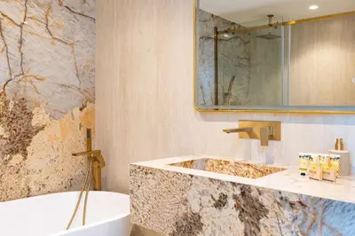 a bathroom with a tub and a sink and a bath tub at PVH - Coastal 2BR with Beach Access - Atlantic Oceana in Dubai