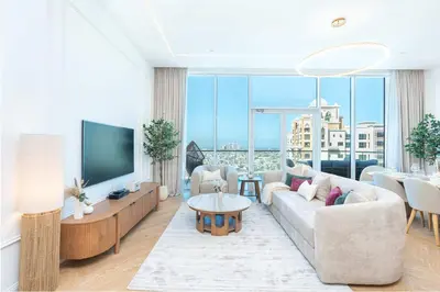 a living room with a couch and a tv at PVH - Coastal 2BR with Beach Access - Atlantic Oceana in Dubai