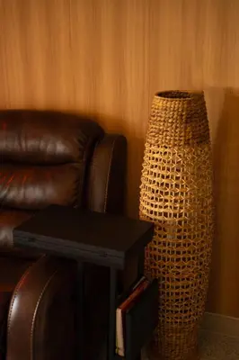 a brown leather chair and a table with a lamp at Meydan Boutique Loft Near Downtown in Dubai