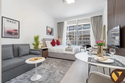a living room with a couch and a bed and a table at Vogue JVC Luma22 near Circle Mall, Studio Apartment with Balcony and Vibrant Community View, Access to all Amenities in Dubai