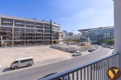 a white van parked in front of a building at Vogue JVC Luma22 near Circle Mall, Studio Apartment with Balcony and Vibrant Community View, Access to all Amenities in Dubai