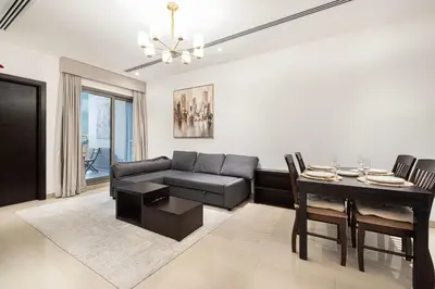 a living room with a couch and a table at Enjoy 8-Day NYE Spectacles with Burj Khalifa View in Dubai