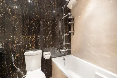 a bathroom with a toilet and a bath tub at Enjoy 8-Day NYE Spectacles with Burj Khalifa View in Dubai