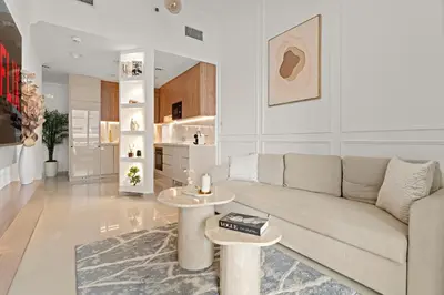 a living room with a couch and two tables at VayK - Vibrant and Great 1BR in the Marina in Dubai