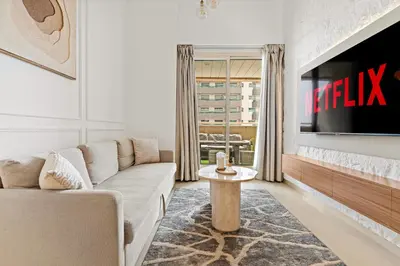 a living room with a couch and a tv at VayK - Vibrant and Great 1BR in the Marina in Dubai