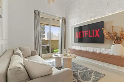 a living room with a couch and a tv at VayK - Vibrant and Great 1BR in the Marina in Dubai