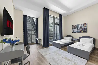 a living room with a couch and a table at Vayk - Spacious and Vibrant 2BR Apartment in Business Bay in Dubai
