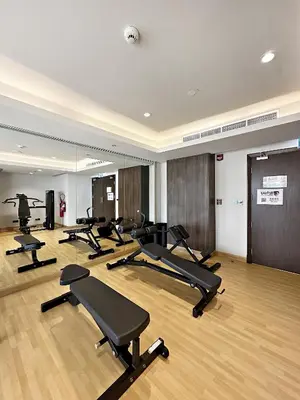 a gym with a row of treadmills and mirrors at Vayk - Spacious and Vibrant 2BR Apartment in Business Bay in Dubai