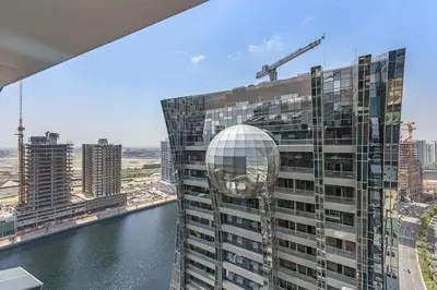 a building with a ball on the side of it at Vayk - Spacious and Vibrant 2BR Apartment in Business Bay in Dubai