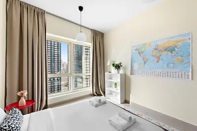 a bedroom with a large window with a map on the wall at VayK - Welcoming and Warm 2BR in JLT in Dubai