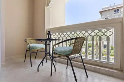 a table and two chairs in front of a window at VayK - Stylish 1BR in Palm Jumeirah with Secluded Beach Access in Dubai