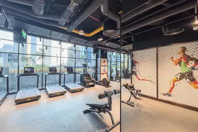 a gym with a bunch of treadmills and machines at Elevated 2 Bedroom with Khalifa view in Peninsula in Dubai