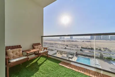 a living room with a view of an airport at Chic 1BR Getaway in Tulip Oasis 9 Majan in Dubai