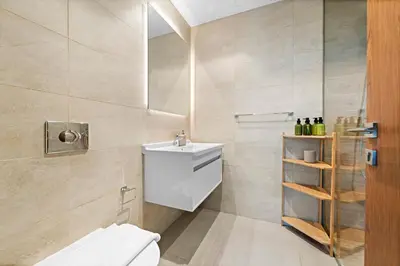 a bathroom with a white toilet and a sink at VayK - Chic Marina-Front 1BR in a Luxurious Location in Dubai