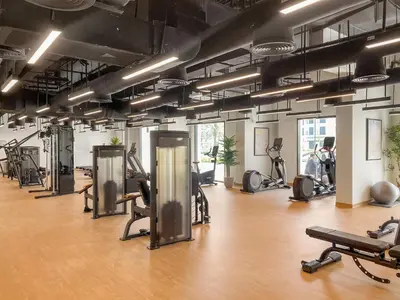 a gym with several treadmills and exercise bikes at VayK - Chic 2BR in Town Square with Pool View in Dubai