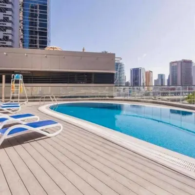 a swimming pool on the roof of a building at Heart of Downtown Luxury 1BHK Dunya in Dubai