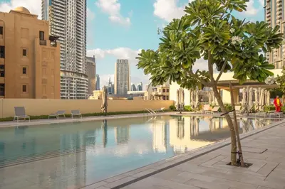a swimming pool in a city with tall buildings at VayK - Iconic 1BR in Downtown in Dubai