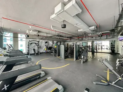 a gym with treadmills and machines in a room at VayK - Bright and Stylish 1BR in Marina in Dubai