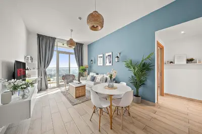 a living room with a table and a couch at VayK - Bright and Stylish 1BR in Marina in Dubai