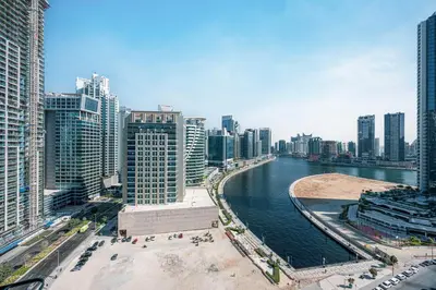 a view of a city with a river and buildings at Stylish Stay at DAMAC Maison Cour Jardin Canalview in Dubai