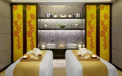 a bathroom with two beds with candles in it at Stylish Stay at DAMAC Maison Cour Jardin Canalview in Dubai