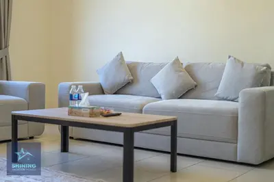 a living room with a couch and a coffee table at Luxury Spacious 1BR JVC 2Bath Pool Gym in Dubai