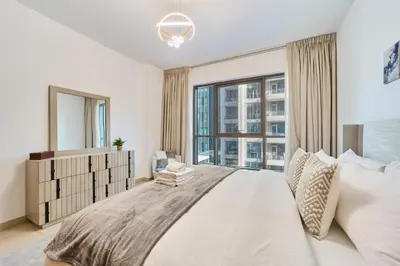 a bedroom with a large bed with a large window at Golden Homes Aqua Bay 1BR-BLVD CENTRAL Downtown Dubai mall in Dubai