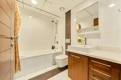 a bathroom with a sink and a toilet and a tub at Golden Homes Aqua Bay 1BR-BLVD CENTRAL Downtown Dubai mall in Dubai