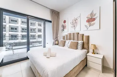 a bedroom with a large bed and a large window at HAVN- 1 Bedroom in Binghatti, Al Jaddaf in Dubai