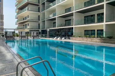 a swimming pool in front of a building at HAVN- 1 Bedroom in Binghatti, Al Jaddaf in Dubai