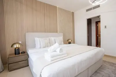 a bedroom with a large white bed with towels on it at Airstay - Stunning 2BR Marina View Retreat - JBR - Monthly Offer Available! in Dubai