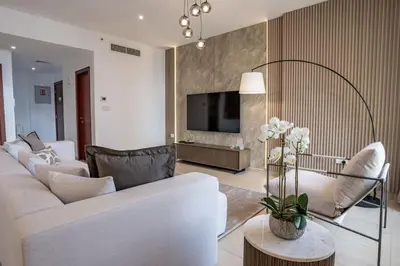 a living room with a white couch and a tv at Airstay - Stunning 2BR Marina View Retreat - JBR - Monthly Offer Available! in Dubai