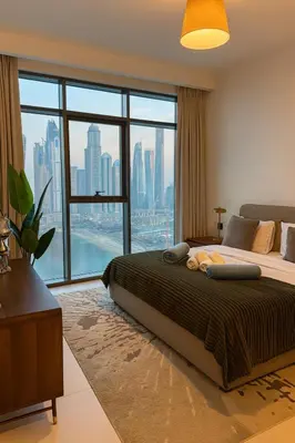 a bedroom with a large bed and a large window at Marina Vista 2BR High Floor Sea View Emaar Beachfront in Dubai