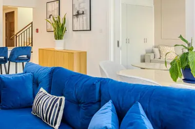 a blue couch sitting in a living room at Luxury 5 bed Villa close to Pool, Gym and Play Areas in Dubai