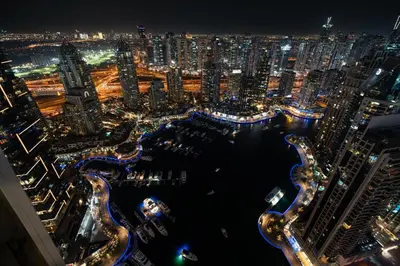 an aerial view of a city at night at GuestReady - 2BR l Marina View + Infinity Pool in Dubai