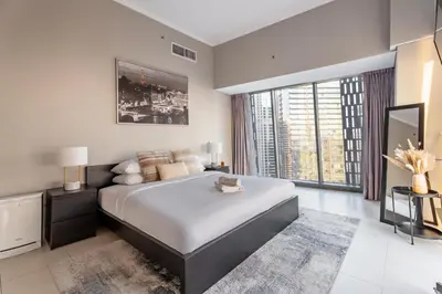 a bedroom with a large bed and a large window at GuestReady - 2BR l Marina View + Infinity Pool in Dubai