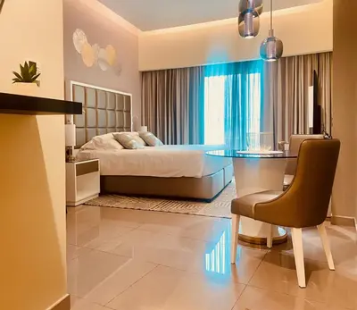 a bedroom with a bed and a glass table at Premium Guest - Majestine Downtown Luxe in Dubai