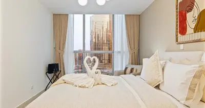 a bedroom with a large bed with a swan on it at Lake View 1BHK in JLT Next to Metro in Dubai