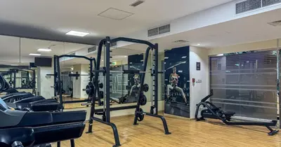 a gym with treadmills and ellipticals in a room at Lake View 1BHK in JLT Next to Metro in Dubai