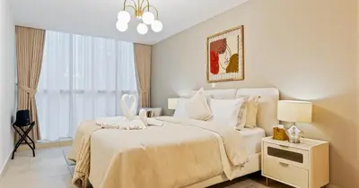 a white bedroom with a bed and a window at Lake View 1BHK in JLT Next to Metro in Dubai