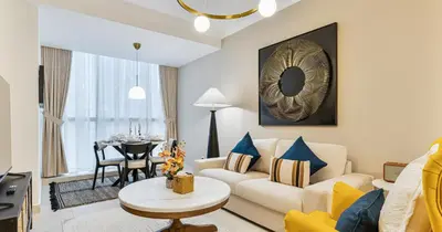 a living room with a couch and a table at Lake View 1BHK in JLT Next to Metro in Dubai
