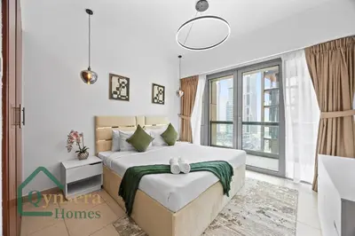 a bedroom with a large bed and a large window at Skyline Bliss Luxury Apartment Dubai in Dubai